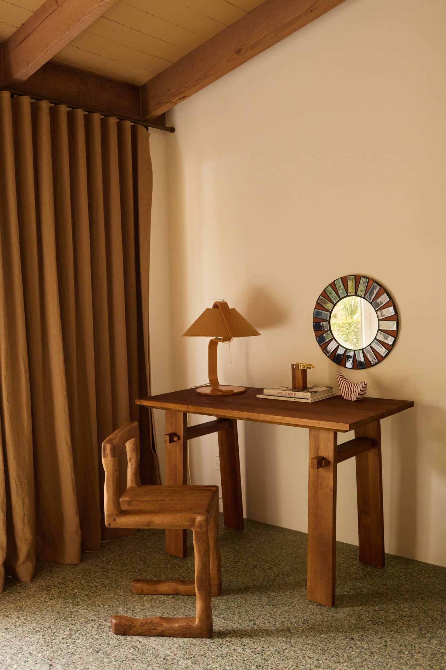 A kitchen detail showing green stone countertops and warm timber cabinetry.