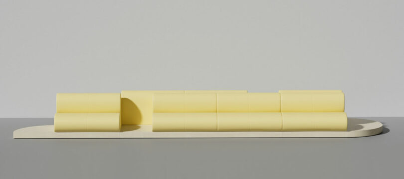 Yellow rectangular modular blocks arranged on a flat plinth.