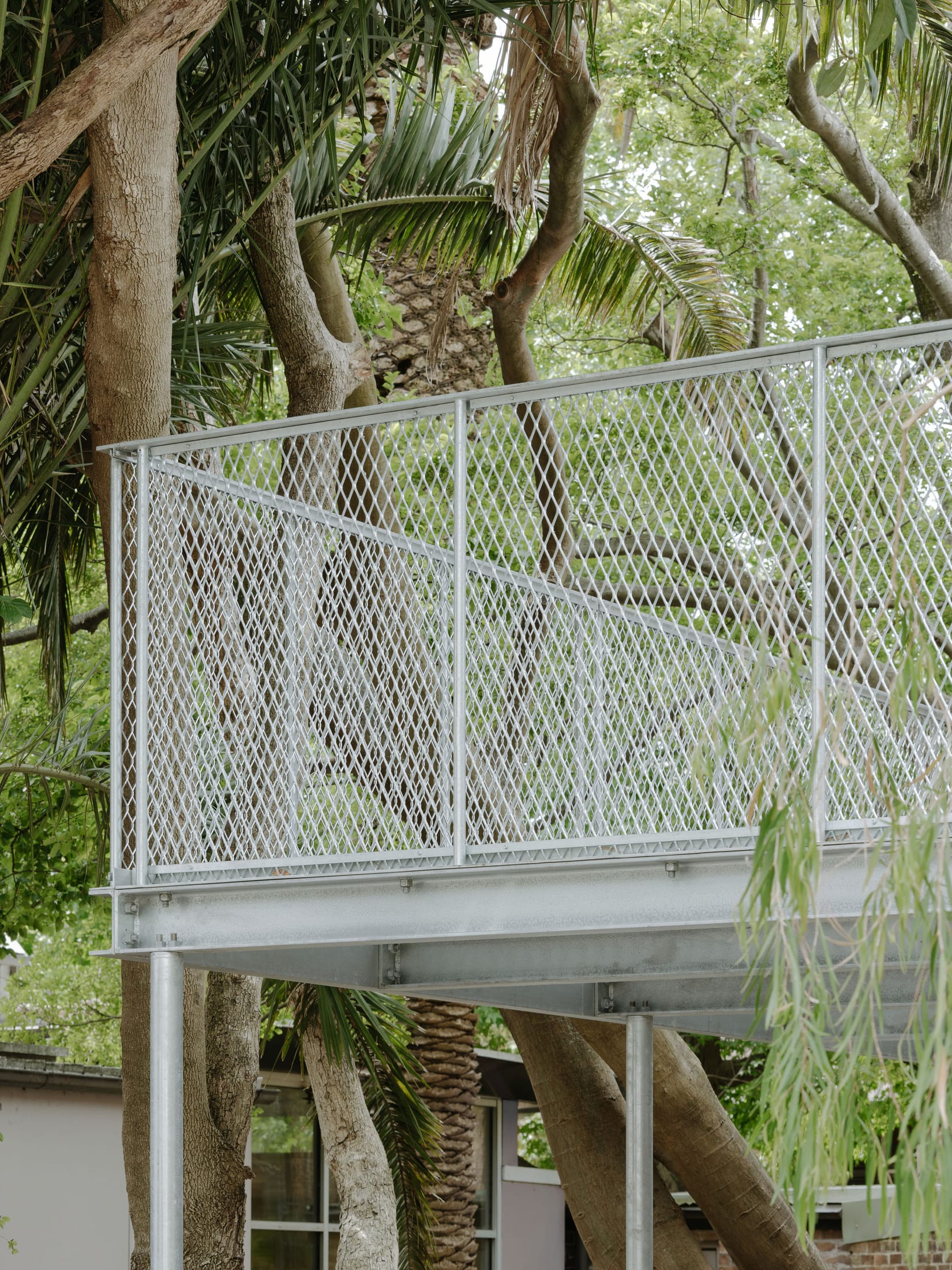 Exterior detail of galvanised steel panels and windows on a traditional terrace house.