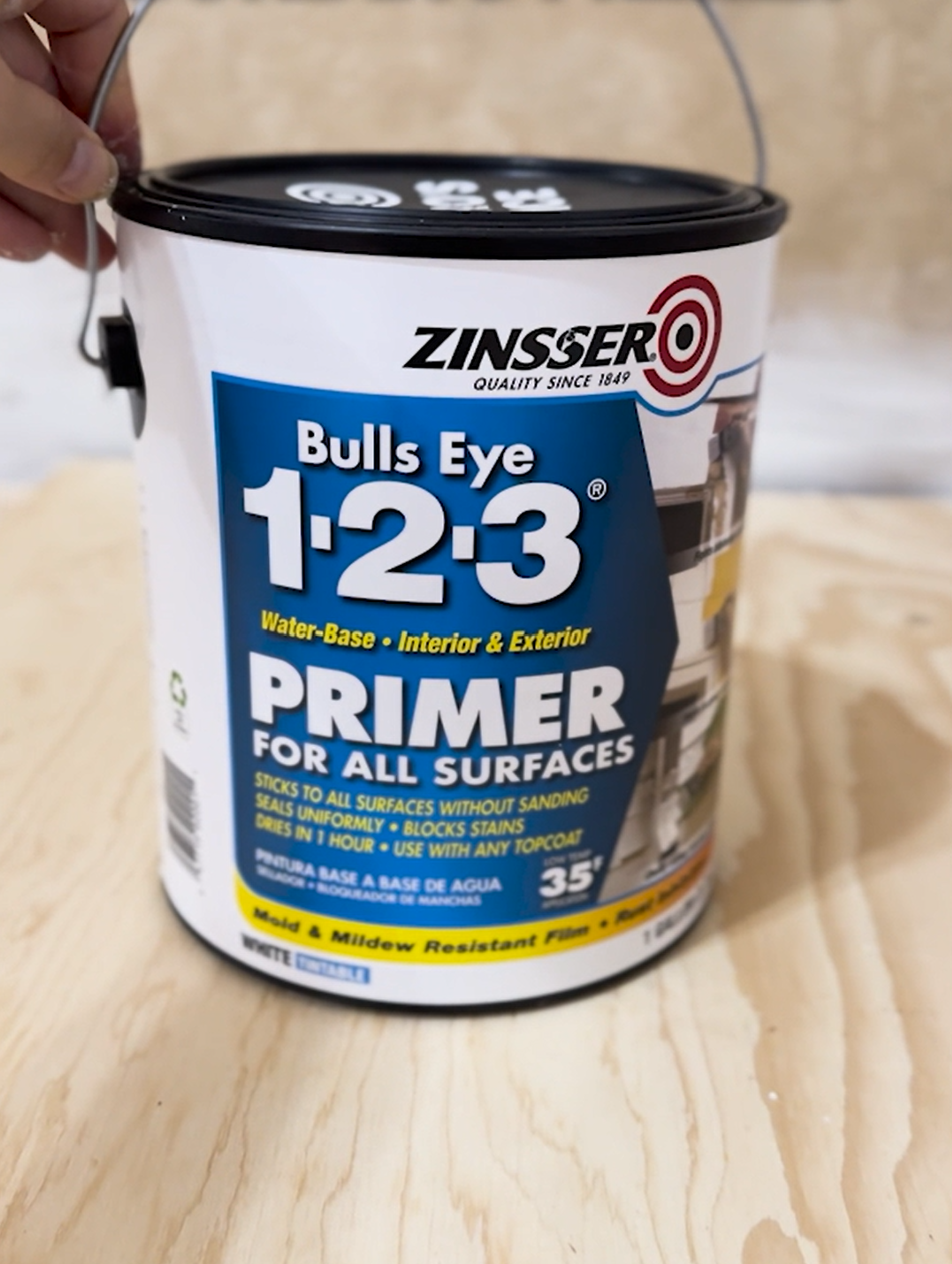 A dining table partially covered in a white bonding primer.