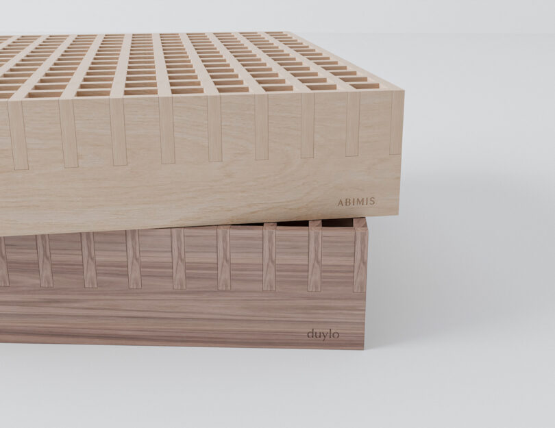 Two interlocking wooden blocks with 'ABIMIS' and 'duylo' engravings.