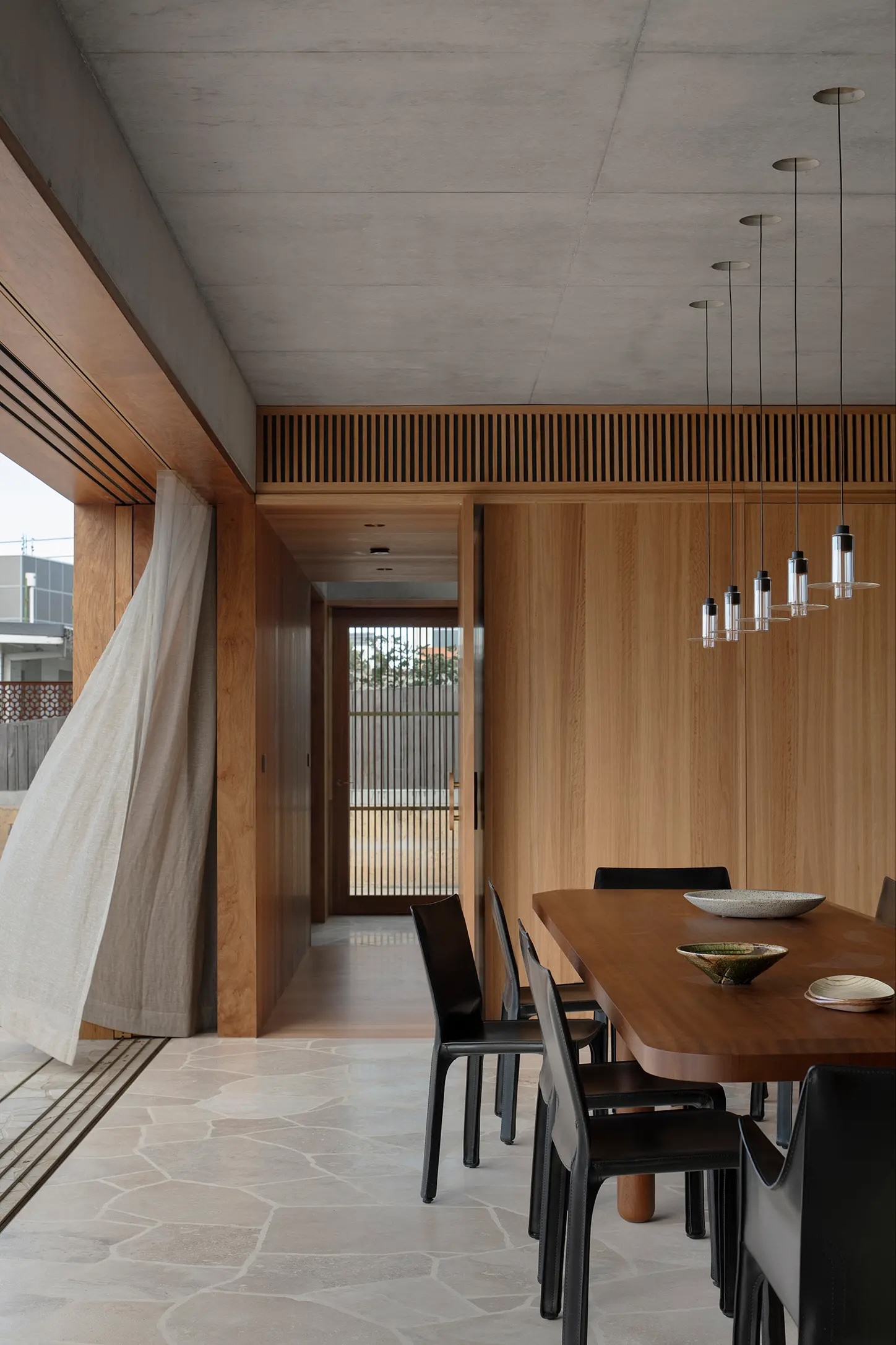 Tall limestone walls of the New Castle residence showing minimalist architectural scale.