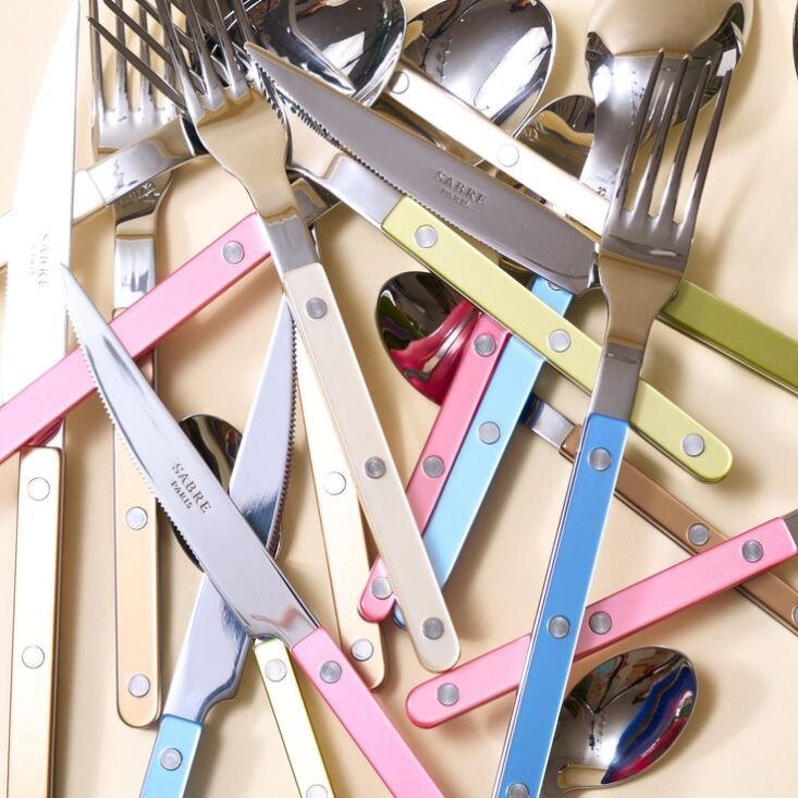 A four-piece set of Sabre Bistrot flatware in a shimmering pearly finish.