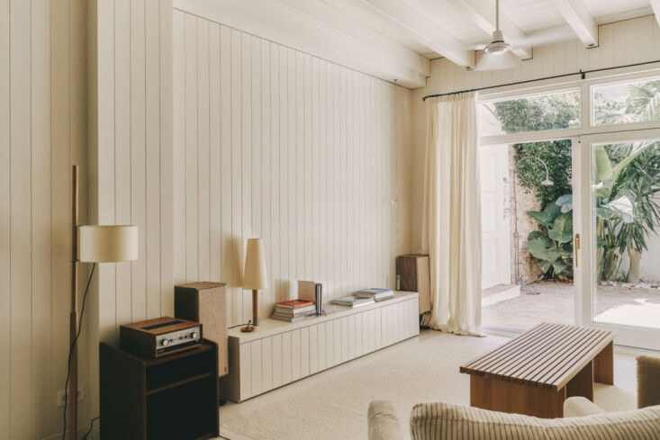 Vertical wood paneling painted in a creamy off-white color.