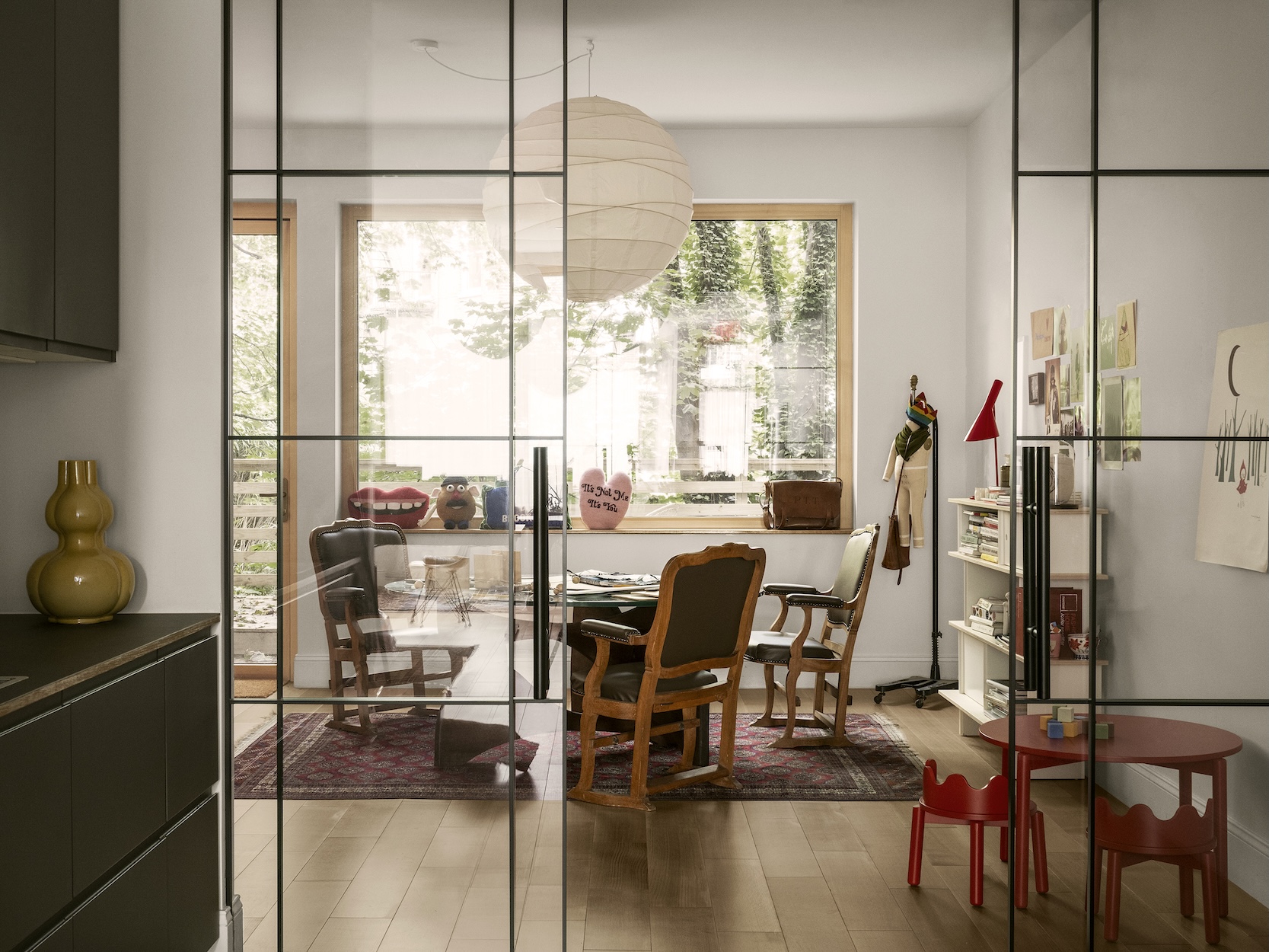 Sophie's office featuring a glass-topped table and red child-size furniture prototypes.