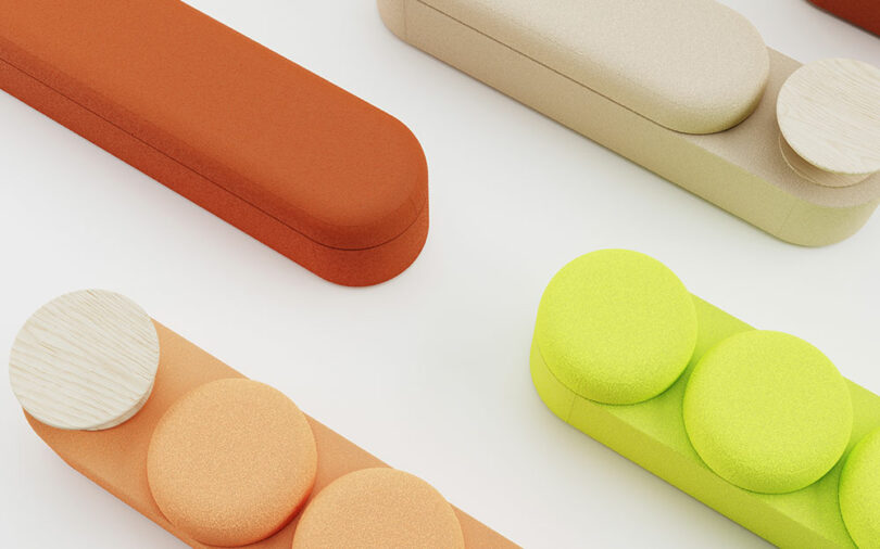 An arrangement of geometric upholstery components and wooden elements in orange, beige, and green.