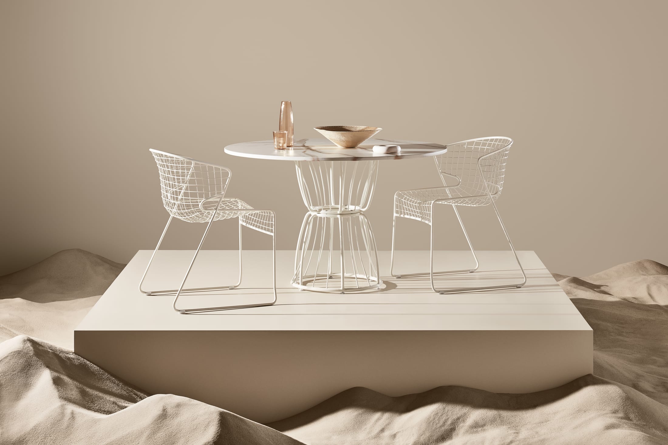 A white latticed sculptural chair from the Ross Didier Nautiloid collection against a dark background.