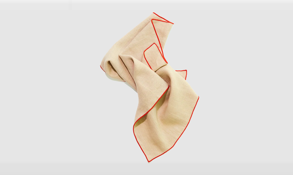 A greige Crimini linen napkin from Madre, illustrating natural earth tones.