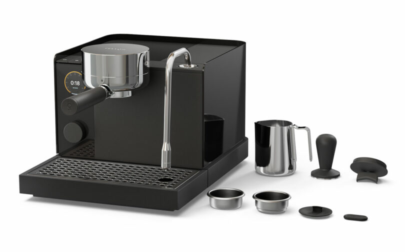 A collection of Fellow espresso accessories including a portafilter, tamper, and milk pitcher laid out neatly.