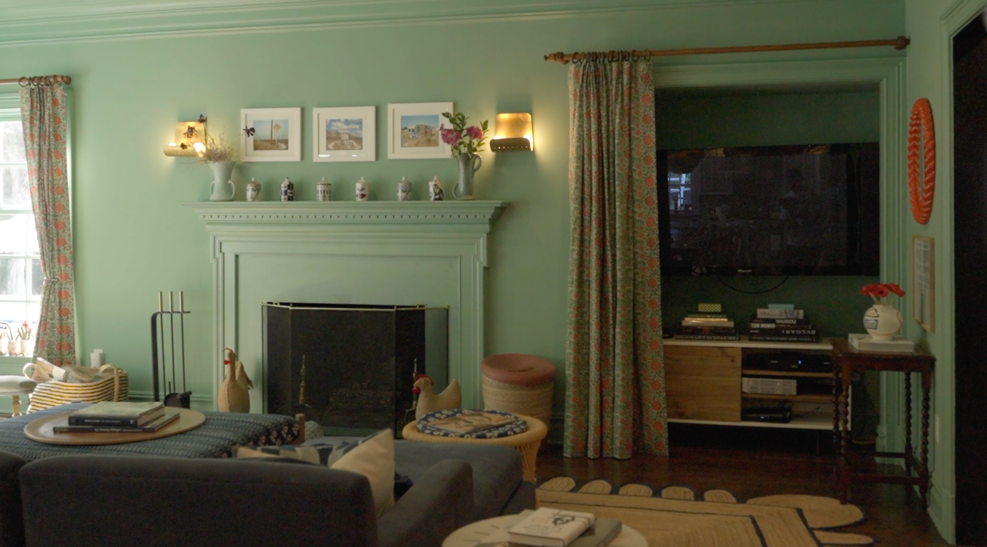 A cozy living area featuring a mix of vintage furniture and layered antique-style textiles.