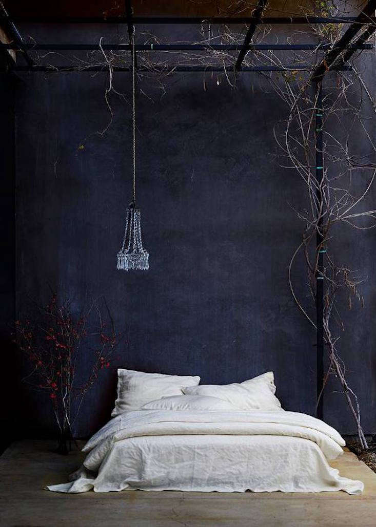 Soft candlelight glowing against a backdrop of neutral-toned bedroom walls.