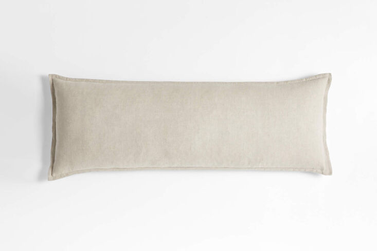 A Crate & Barrel Belgian Flax Linen body pillow in a warm natural shade.
