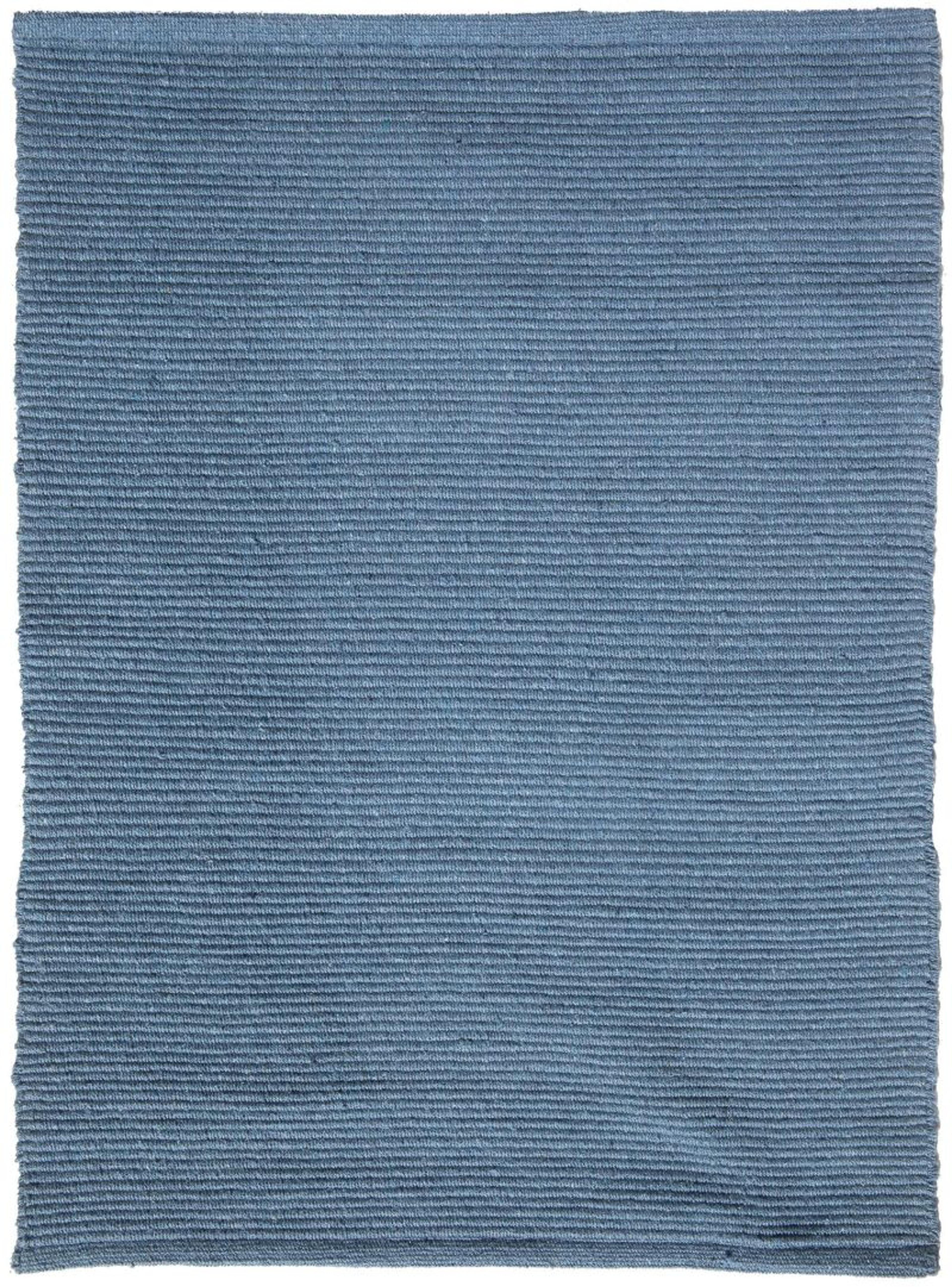 A flat-weave blue denim cotton rug from Hook & Loom showing its tight natural fiber texture.