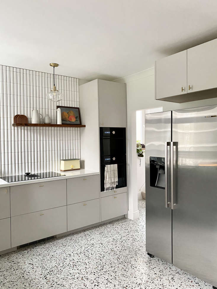 A tall kitchen cabinet tower featuring an integrated microwave and oven.