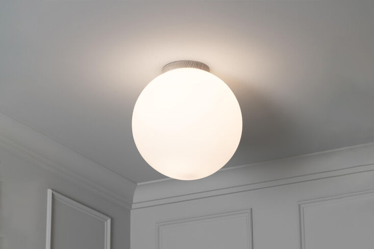 A large round flush-mount globe light fixture on a white ceiling.