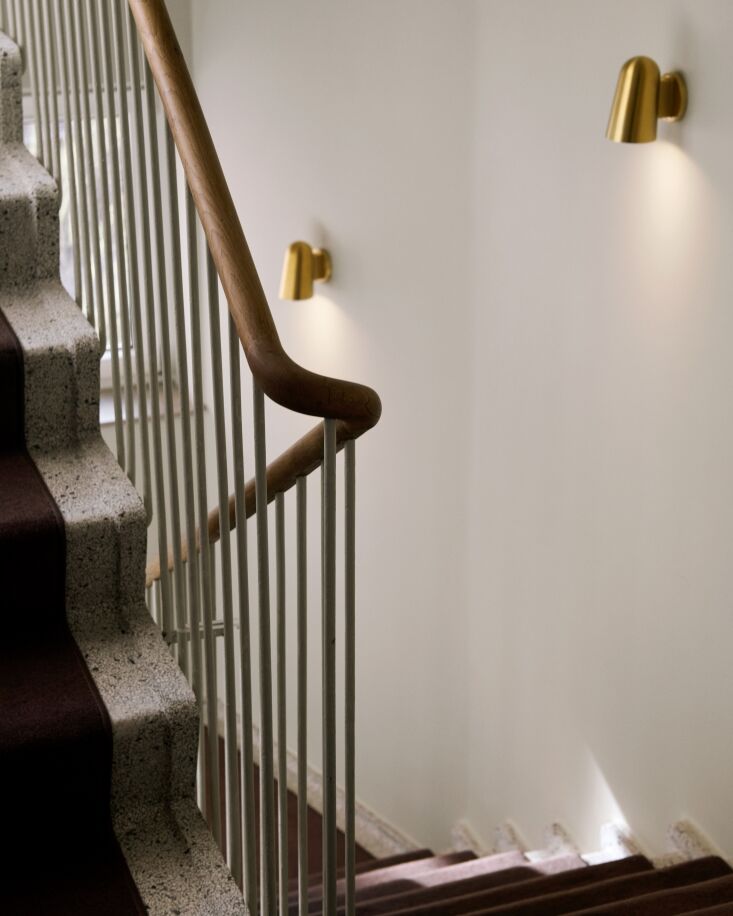 Internal stairwell featuring original terrazzo steps and a handcrafted brass-fitted banister.
