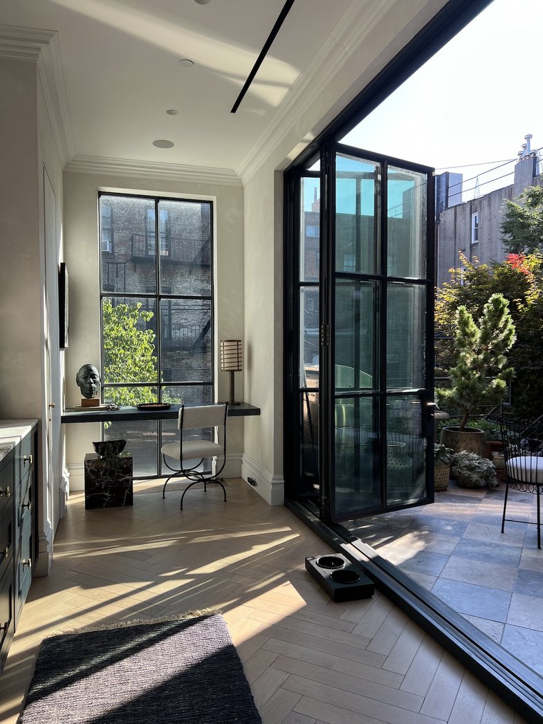 Halibut fillets searing in a pan surrounded by blistered tomatoes, garlic, and chilies.
