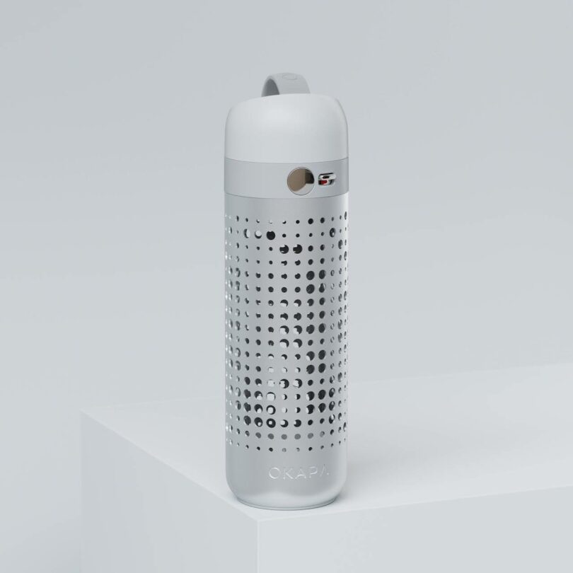 A white and silver reusable water bottle with a perforated aluminum shell and a viewing window.