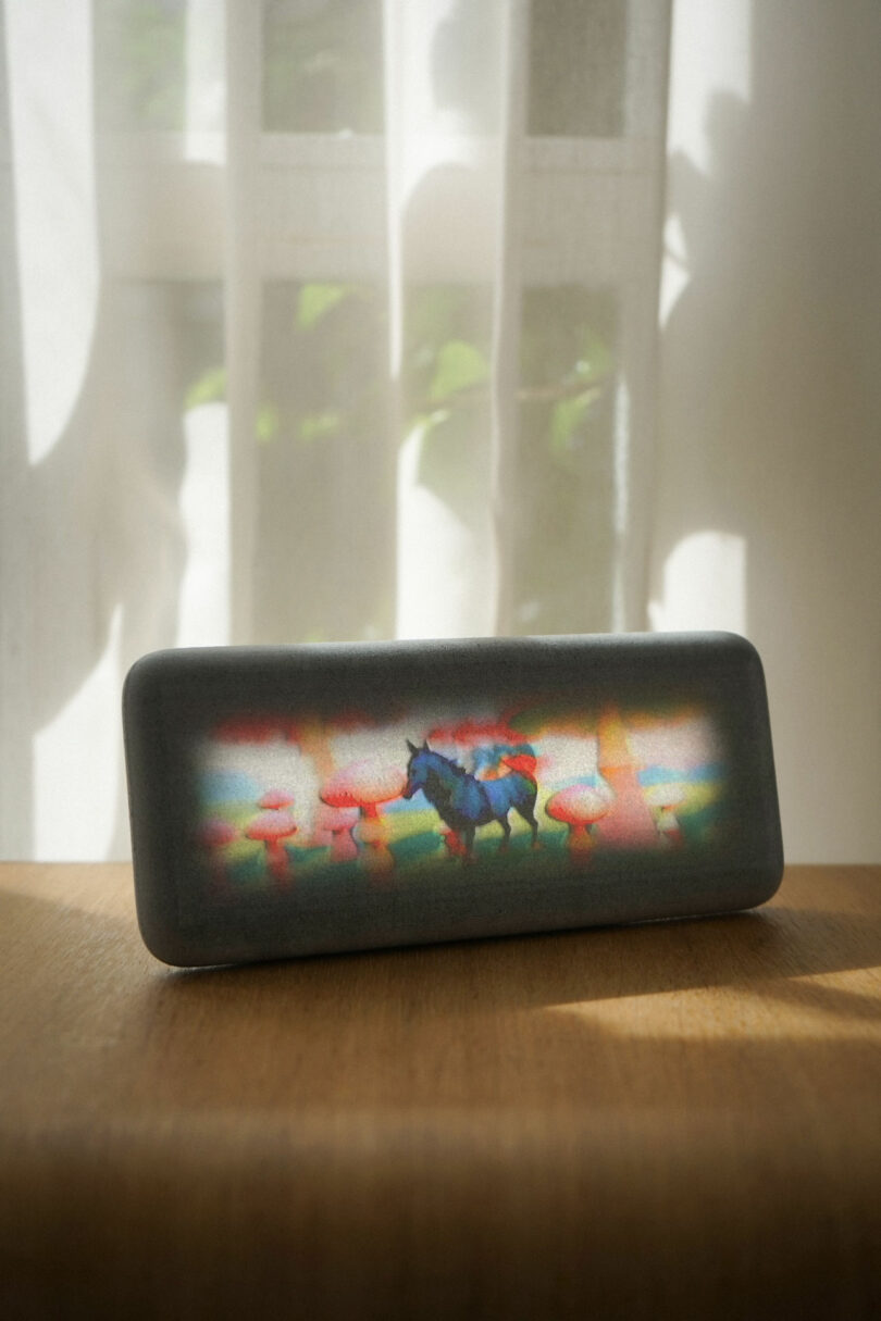 The Modem Dream Recorder displaying a surreal, low-fidelity image of a unicorn and mushrooms.