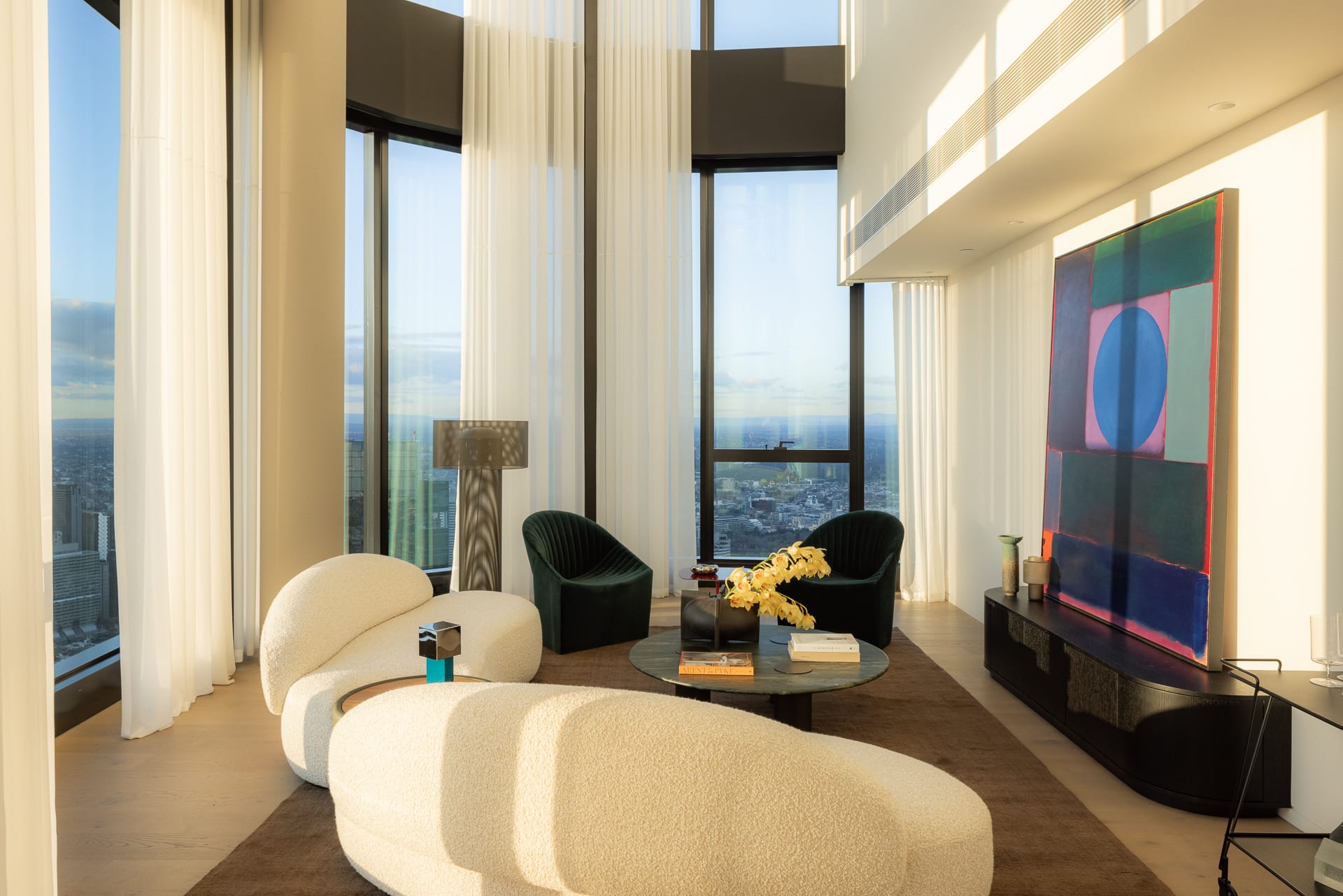 Interior living space featuring natural wood textures adjacent to a large window overlooking the skyline.