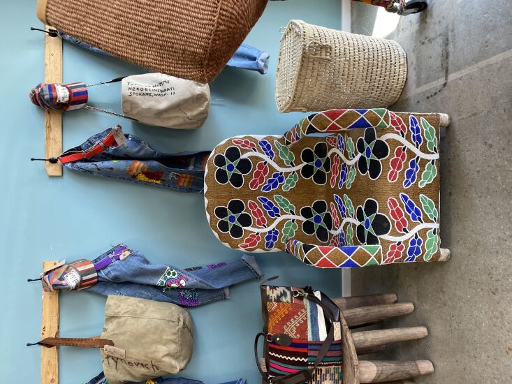 A Nigerian beaded chair with a black and white checkered pattern in a boutique setting.