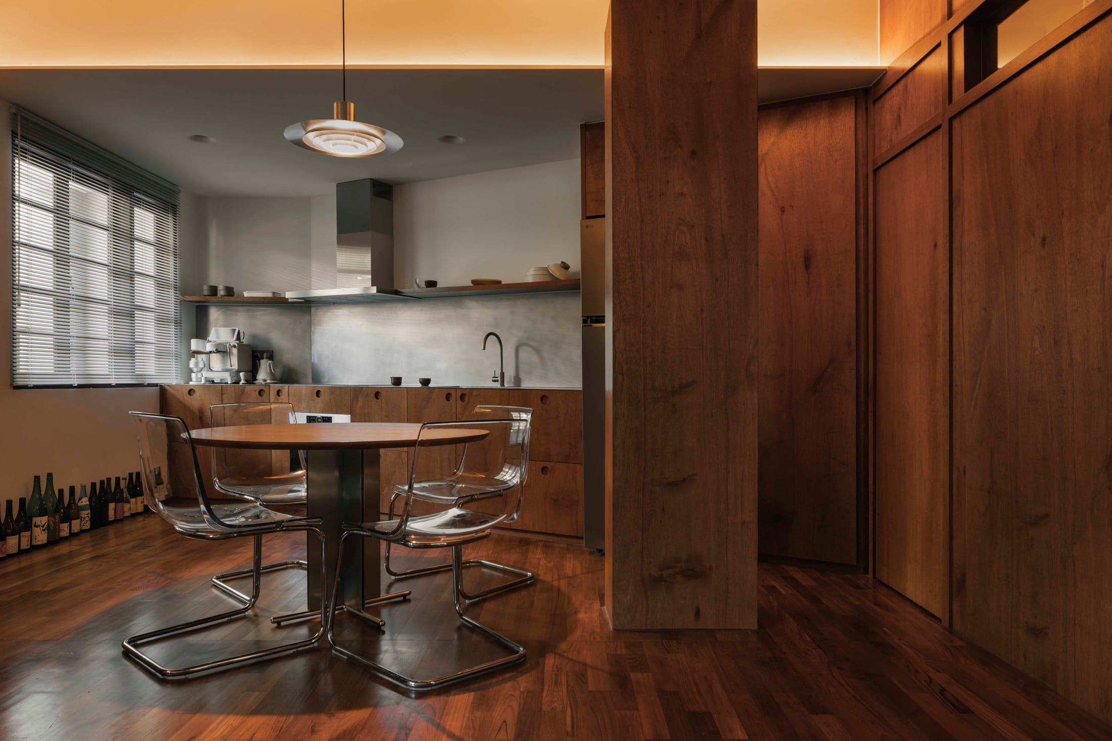 Close-up of a walnut wood storage unit and entryway detailing.