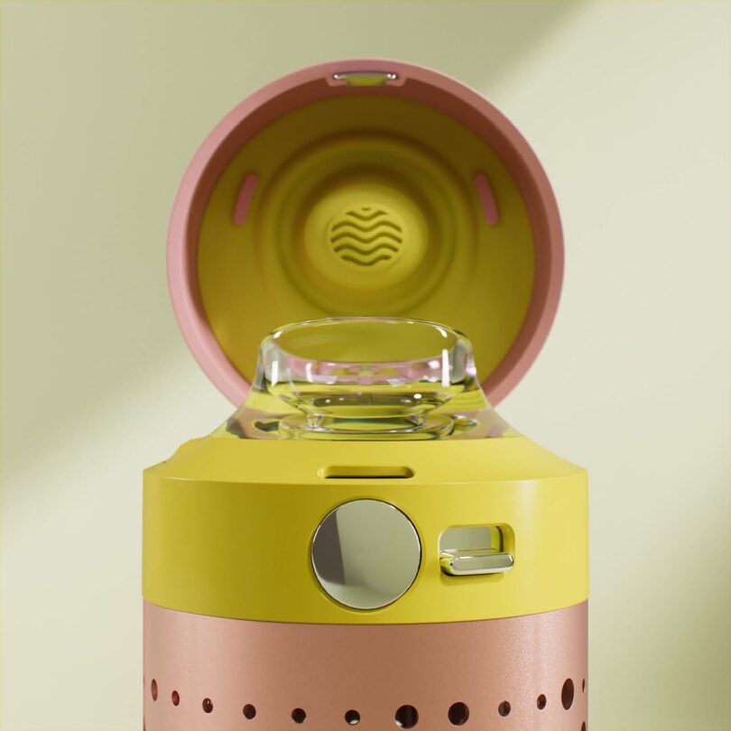 Close-up of an open water bottle lid revealing a clear mouthpiece and a circular metallic button.