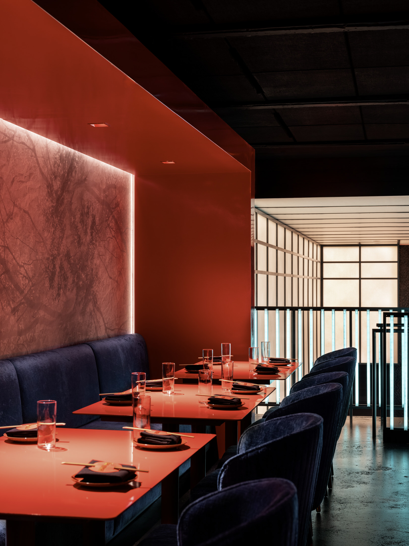 Overview of Haii Keii interior showing the mix of turquoise furniture and red neon lighting.