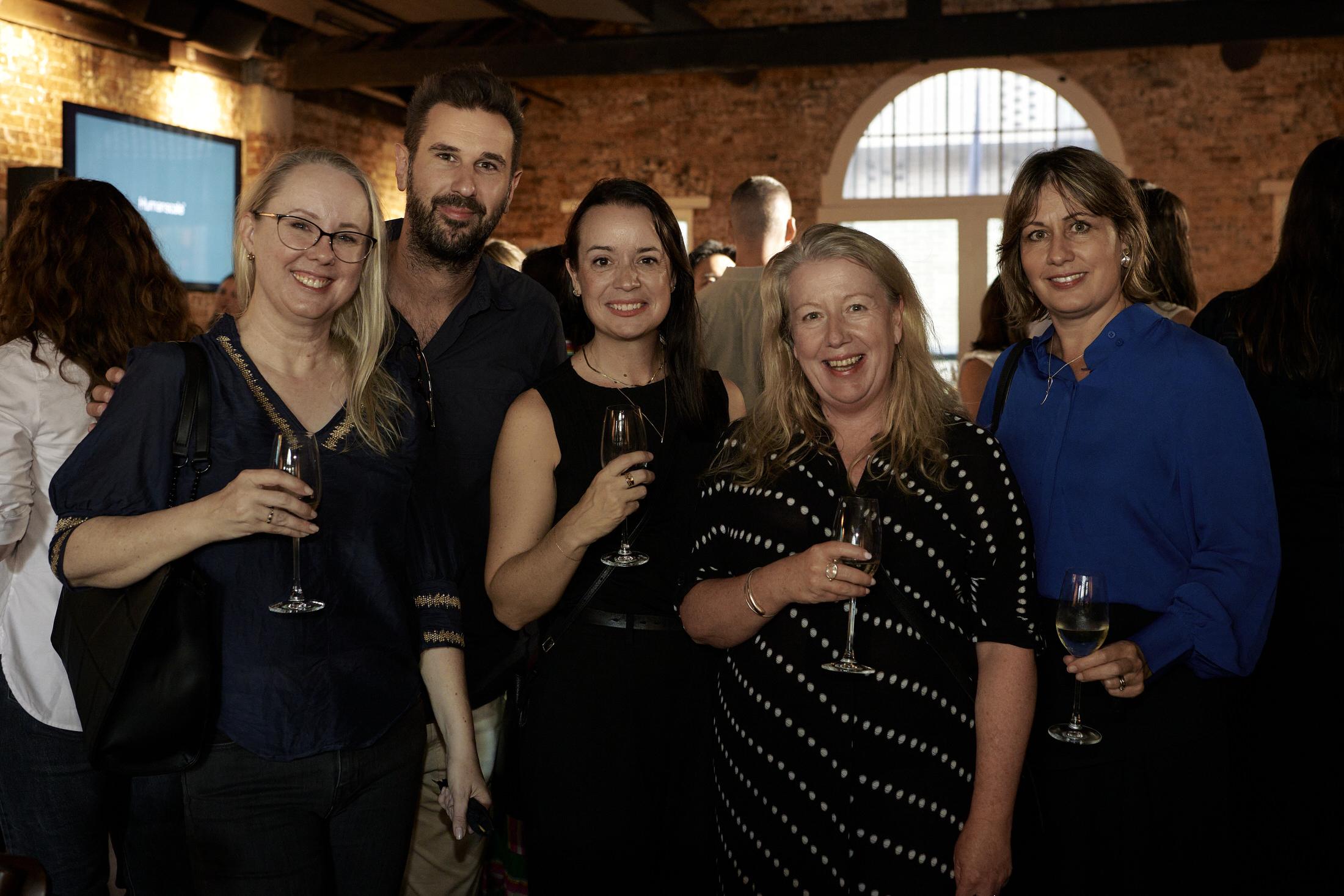 Attendees interacting with ergonomic workstations and sit-stand solutions.