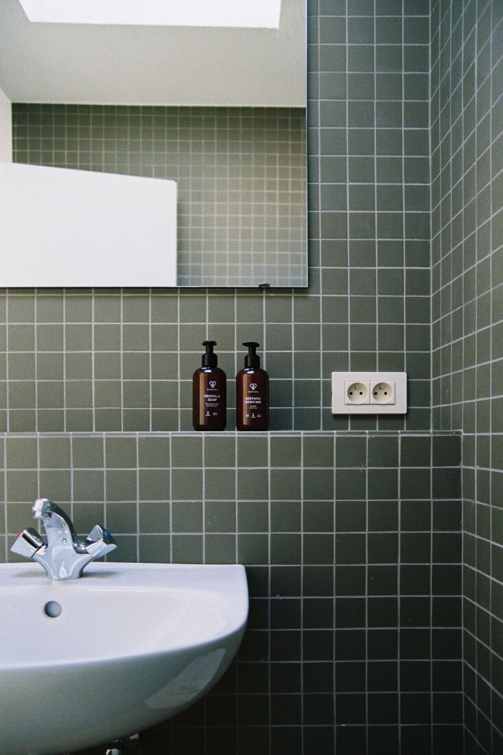 Detail of a bathroom lined with tactile unglazed tiles from Winkelmans.