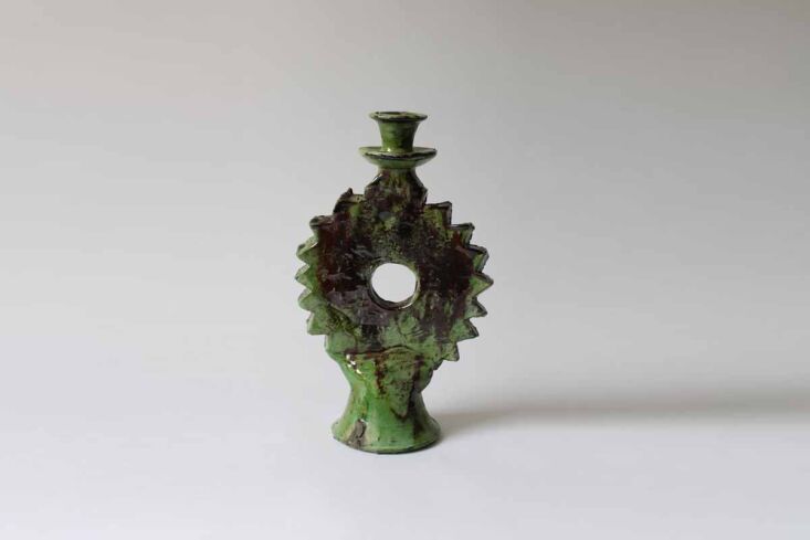 A sculptural Tamegroute Sun Candleholder with a unique circular silhouette.