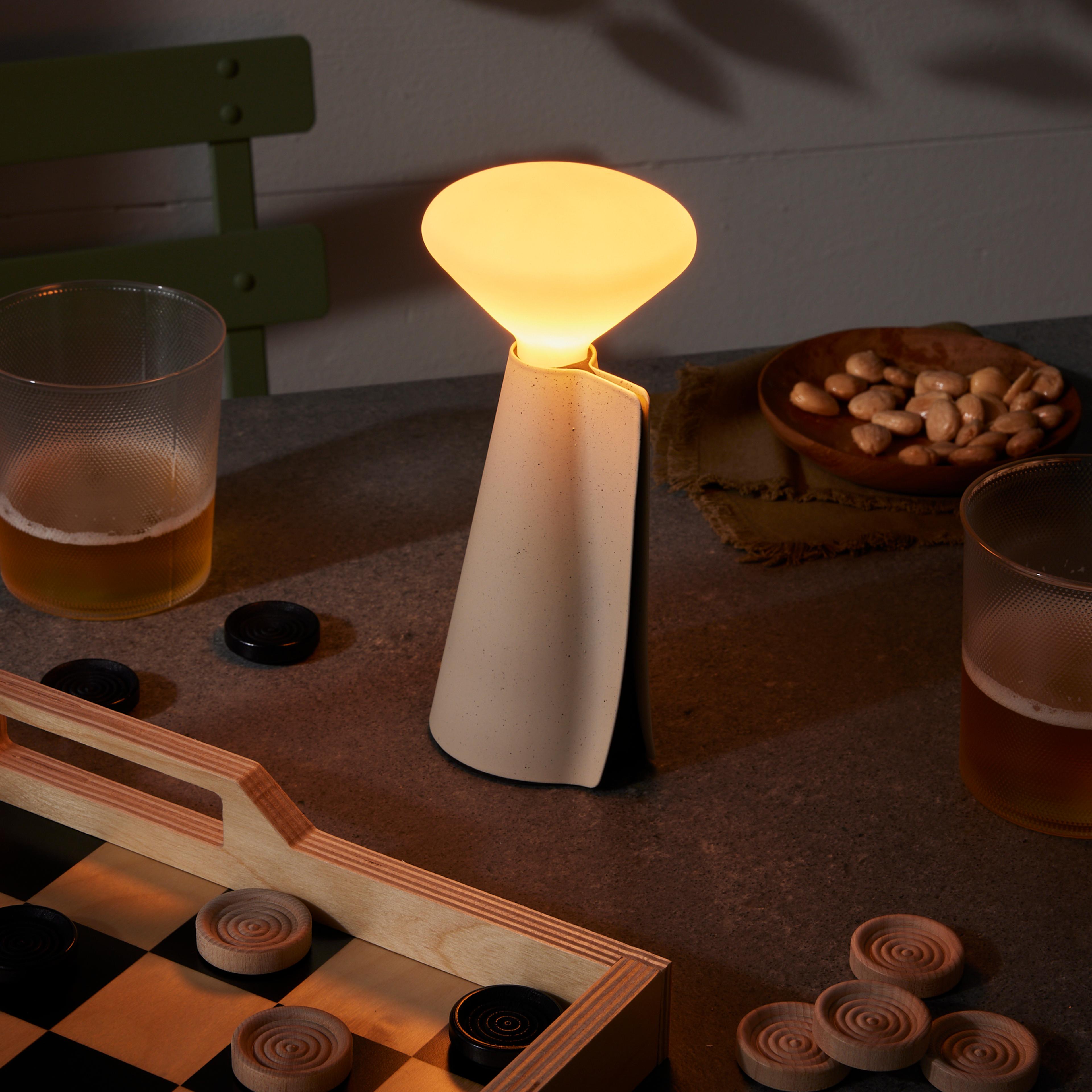 A warm, glowing ambient lamp illuminating an outdoor evening setting.