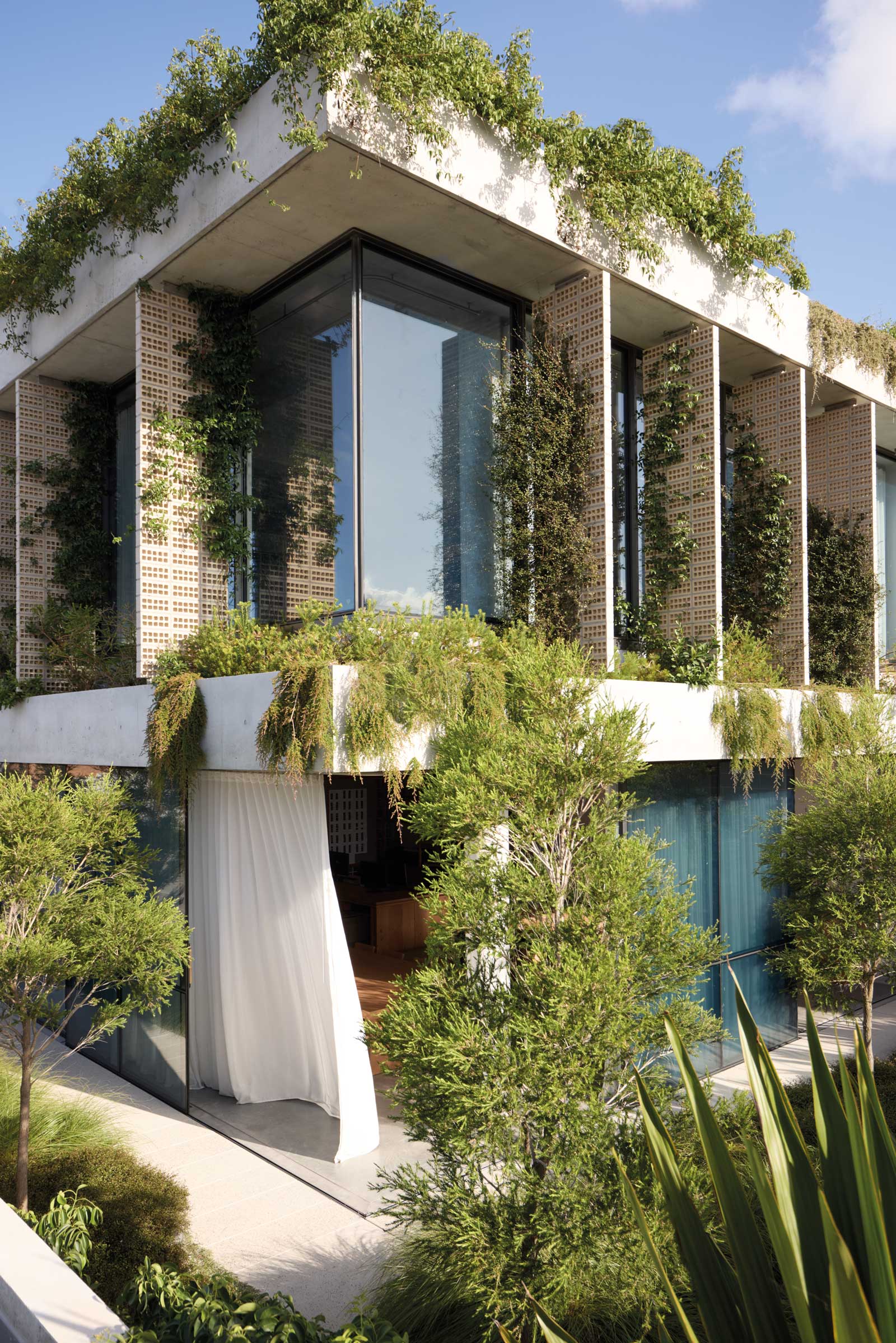 Interior view of a modern landscape architecture office with greenery and design books.