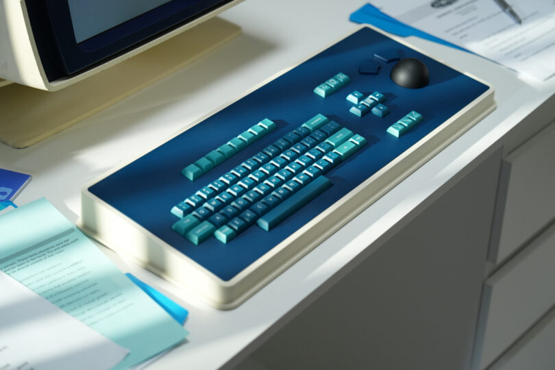 The MDR Dasher keyboard on a desk surrounded by office documents, highlighting its industrial aesthetic.