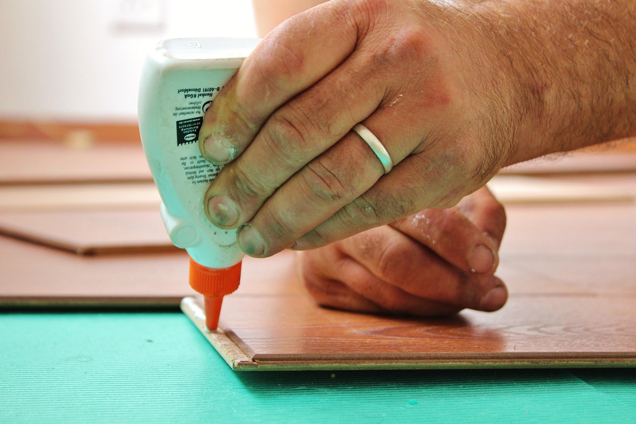 Various sizes of wooden dowels and exterior grade sealant on a workbench.