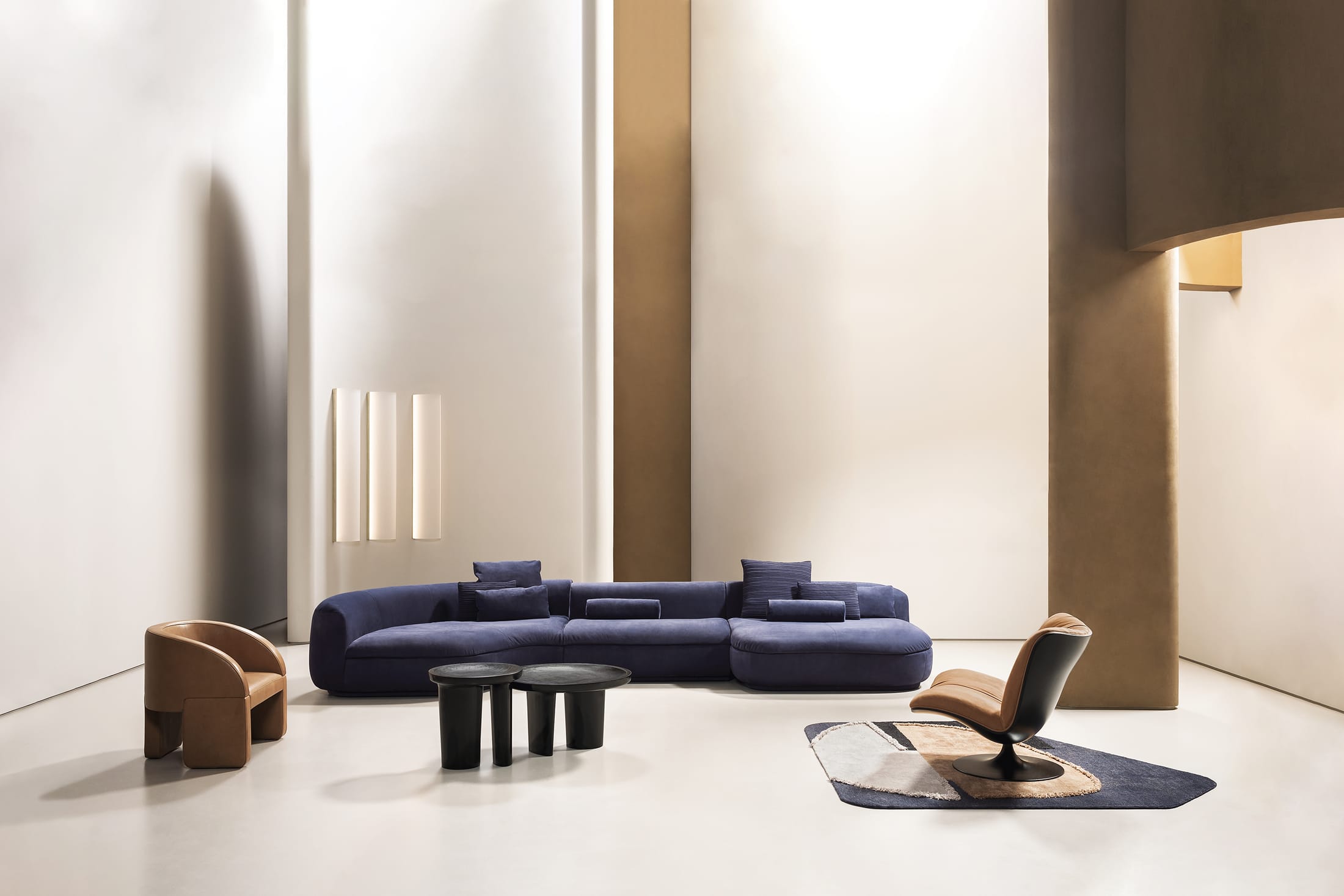 A curved Baxter Piaf sofa arranged in a circular fashion to encourage social engagement.