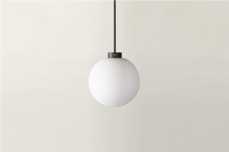 CB2 Marra Black Globe Pendant light featuring a matte black finish and geometric design.