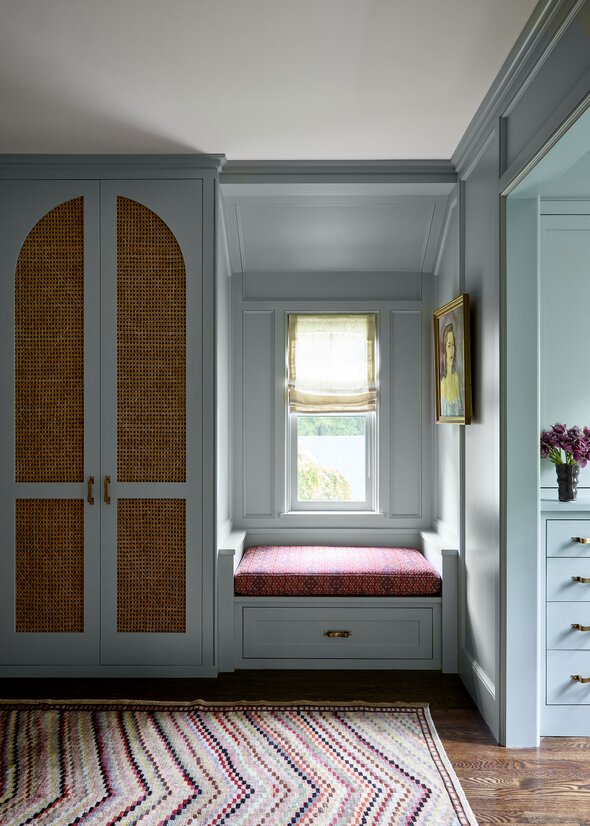 An interior wall painted in a velvety forest green with biophilic accents and soft shadows.