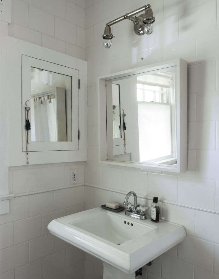 A bathroom vanity mirror with small chrome-tipped bulbs in the sockets.
