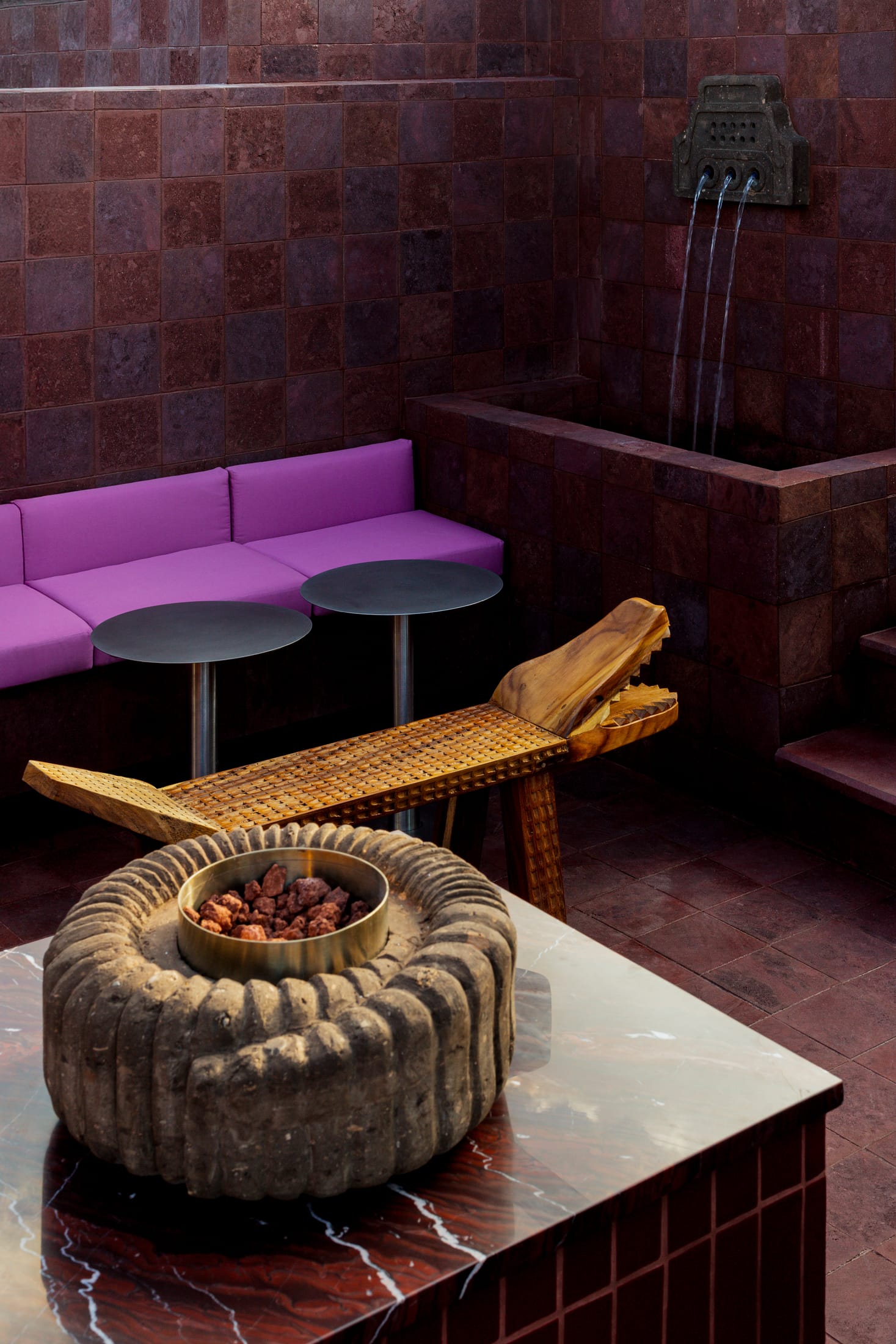 The bar area of Tonana showing the contrast between brass shelving and stone walls.