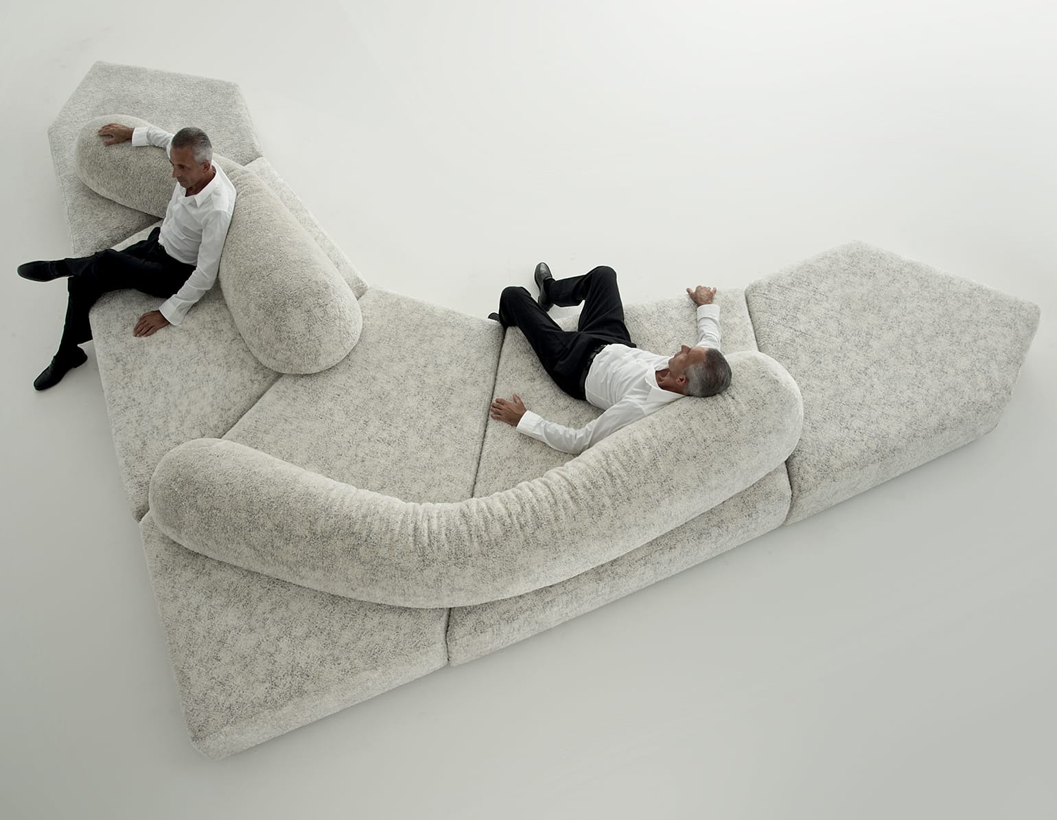 A side profile of the Edra On the Rocks sofa showing the thick, textured fabric and organic curves.
