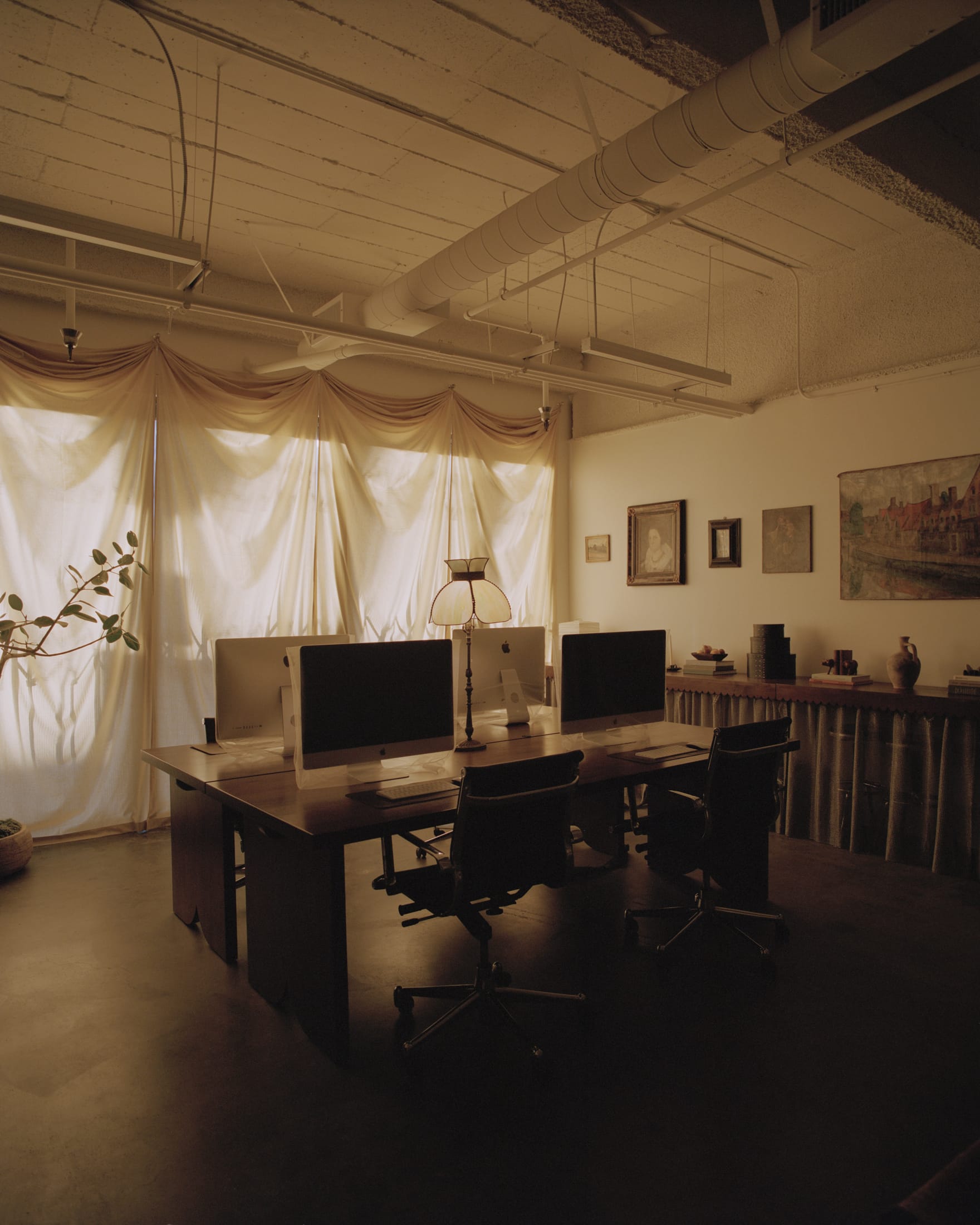 A streamlined workspace area with minimal tech visibility and focused lighting.