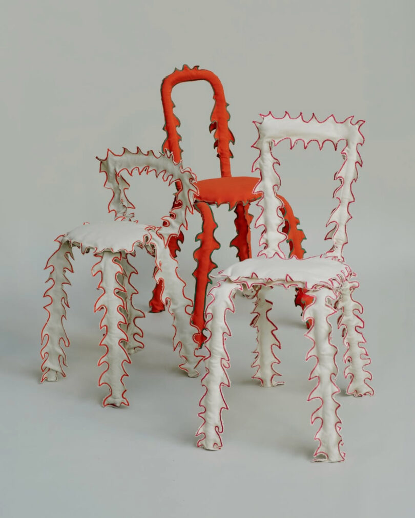 Three chairs with wavy, textured outlines in contrasting orange and white tones.