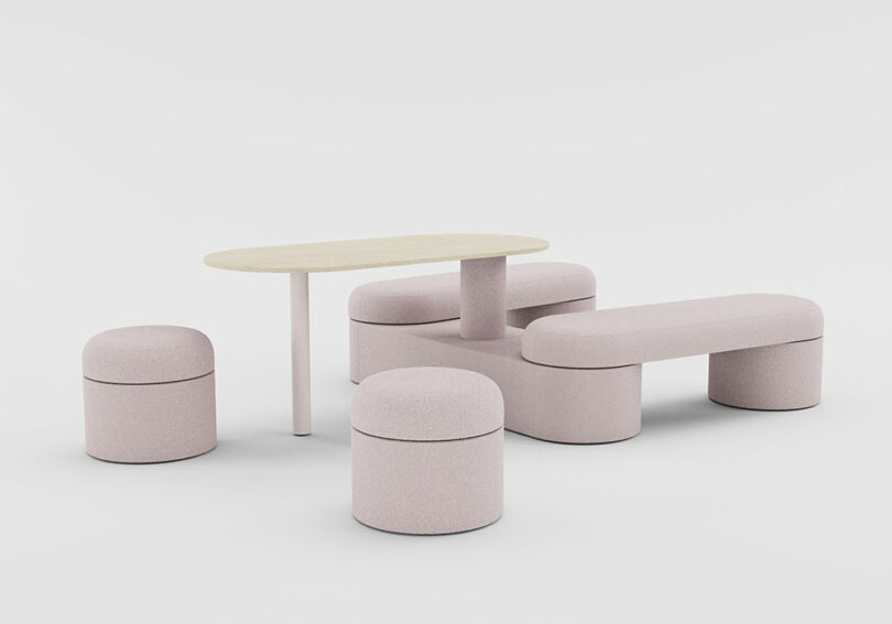 A light pink modular furniture set including stools, a curved bench, and a small table.