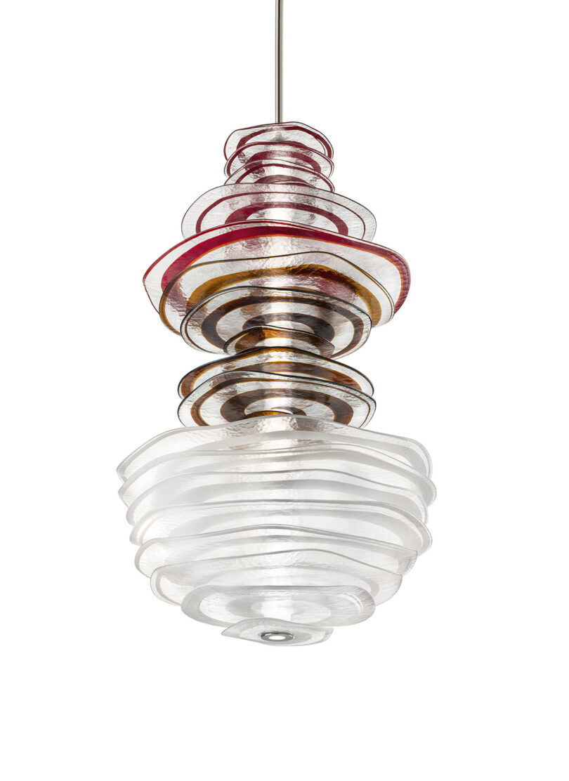 A pendant light fixture with layered wavy glass discs in clear, amber, and red tones.