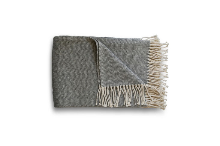 A close-up of a textured cotton herringbone throw in an oyster grey color.