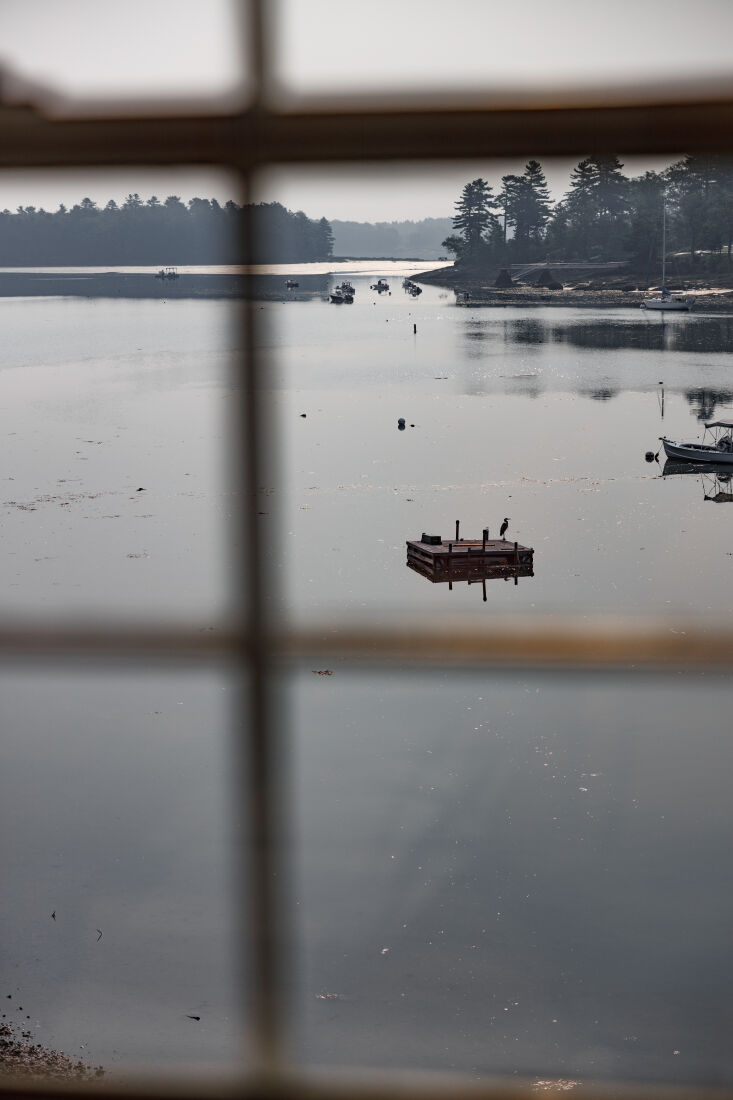 The coastal kitchen building at dusk, showing the seasonal transition of the property.