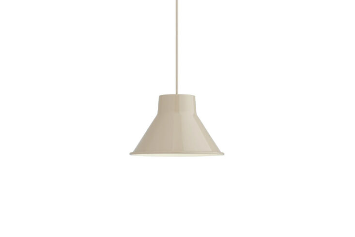 Muuto Top Pendant lamp in a soft sand finish hanging against a minimalist background.