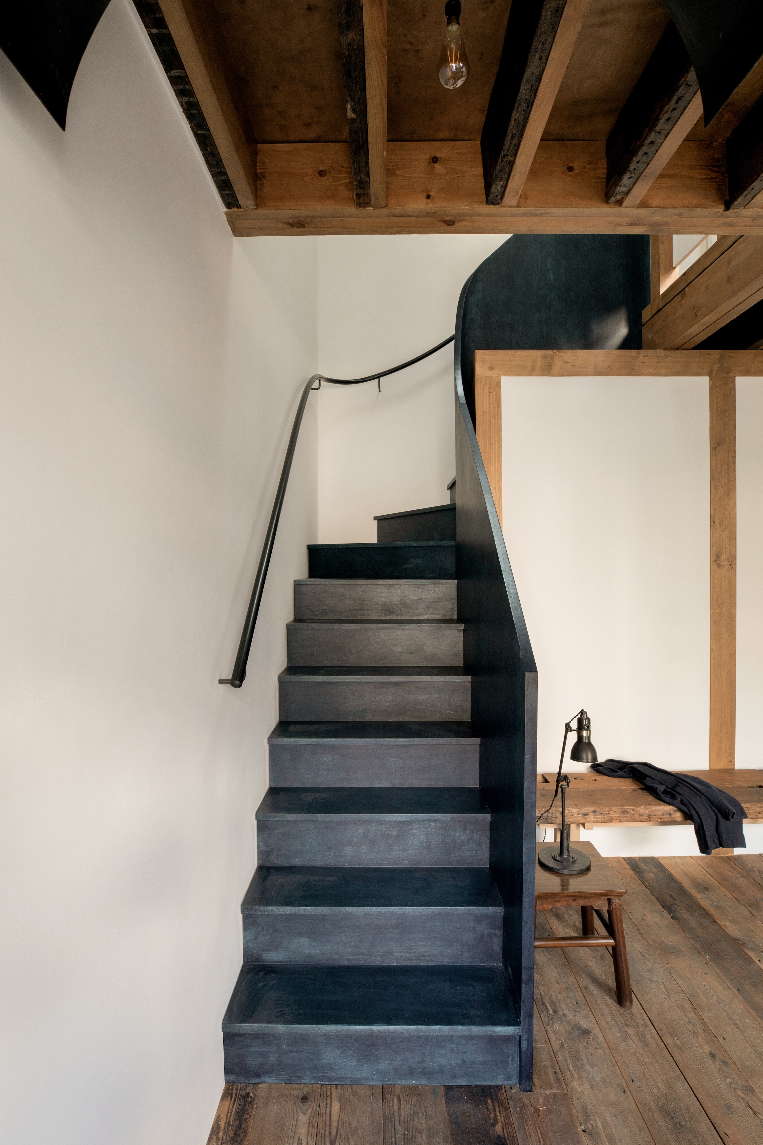 A midnight blue sculptural staircase made of hand-folded plywood.