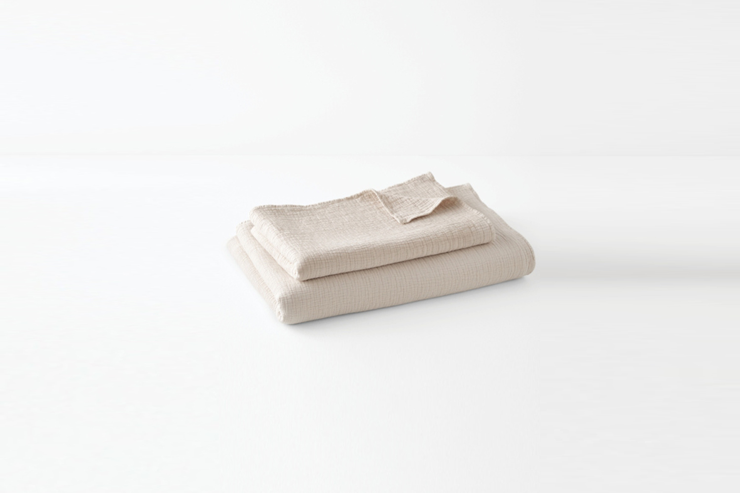 A stonewashed organic cotton blanket showing a soft, lived-in texture.